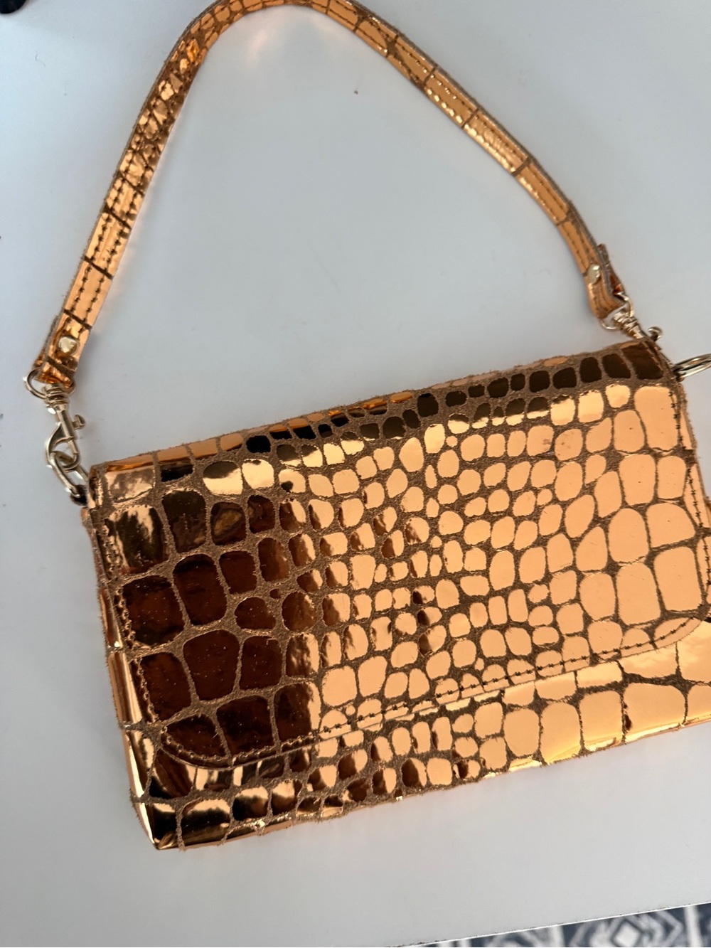 Croc-Embossed Metallic Clutch in Rose Gold